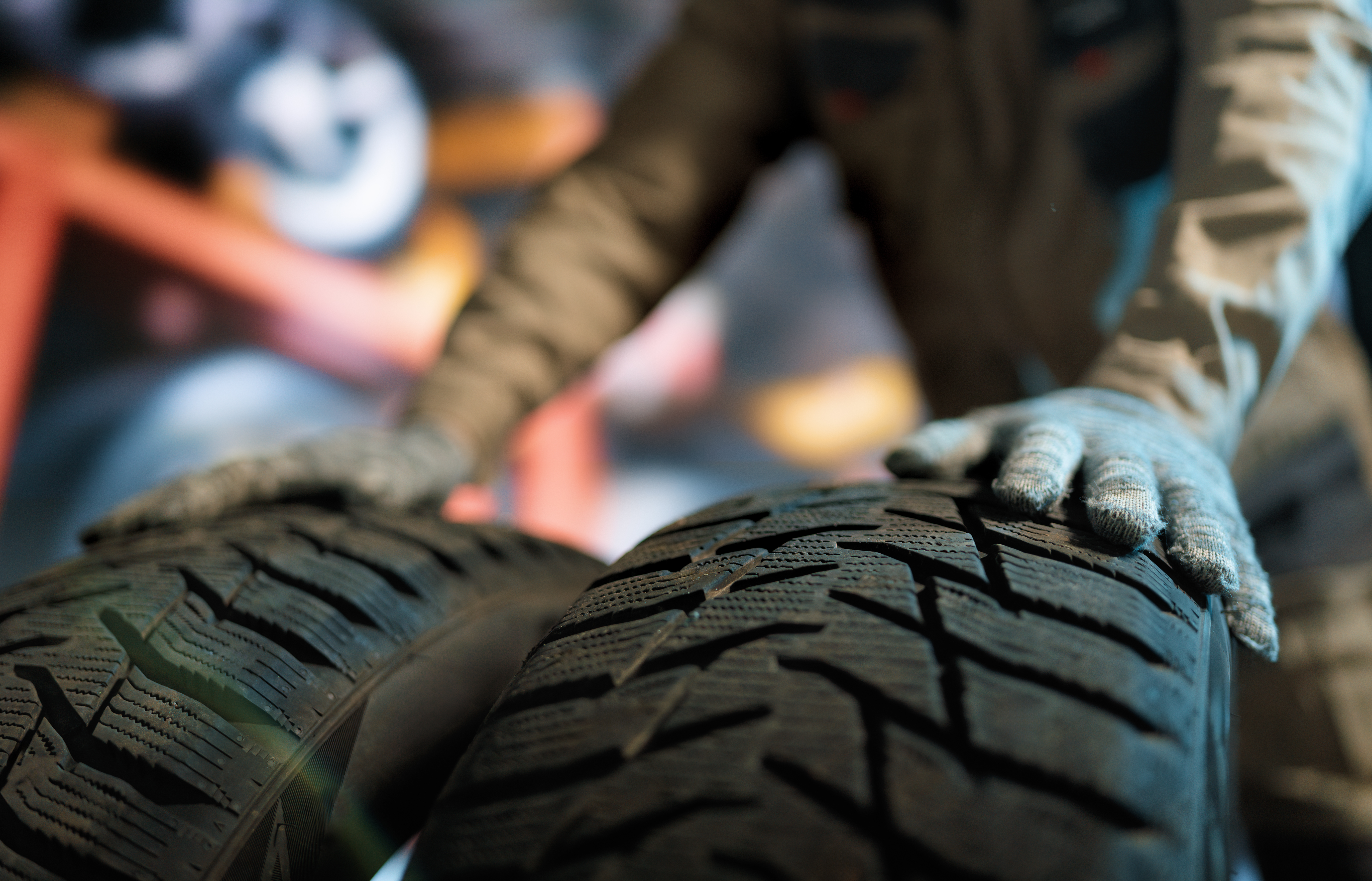 Mechanic in the Kayuco shop holding new tires