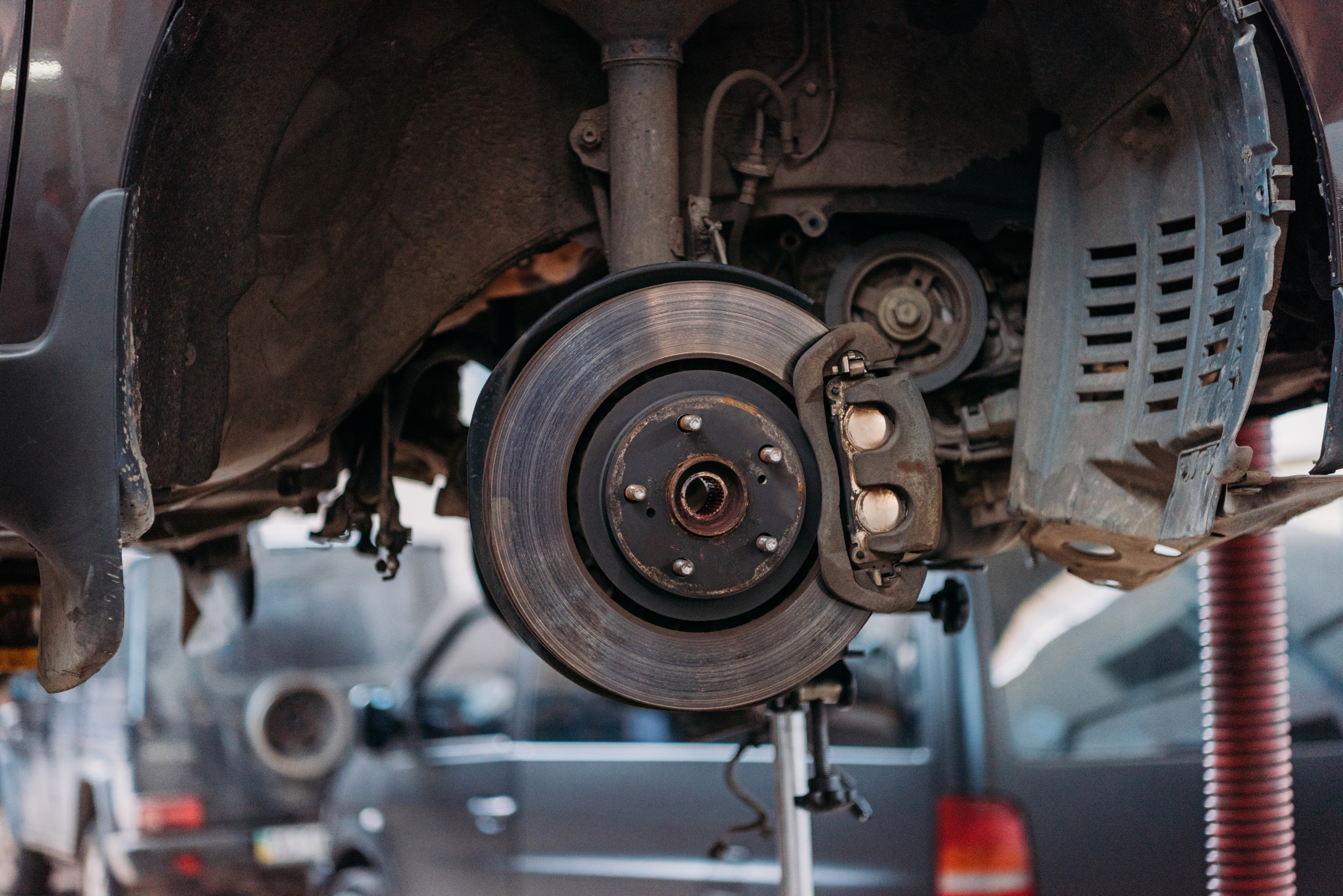 Brake rotor exposed on a car in the Kayuco service bay